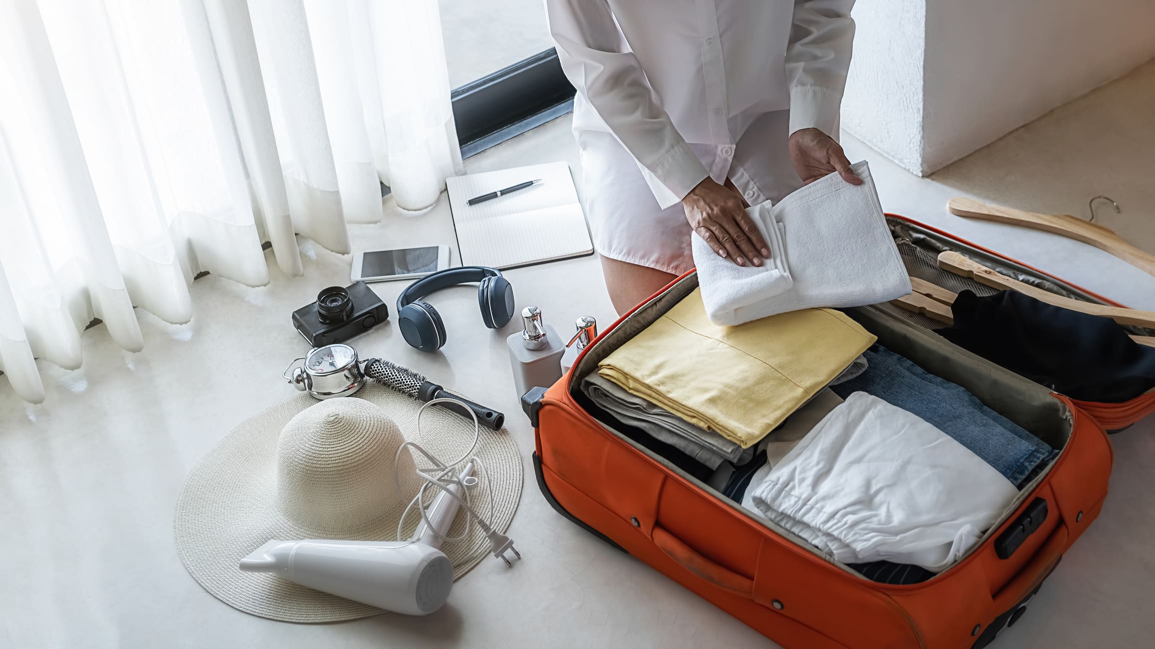 A person packing their suitcase