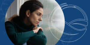 woman looking at the rain out of the window